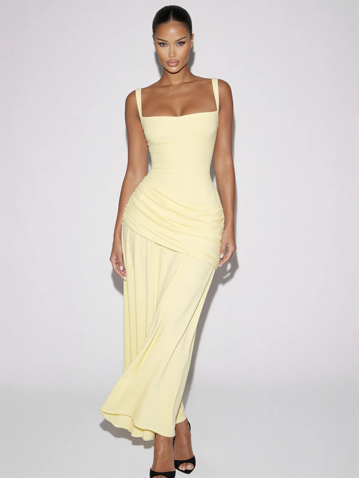 Model wearing the Améliane butter yellow square-neck maxi dress with ruched hip draping