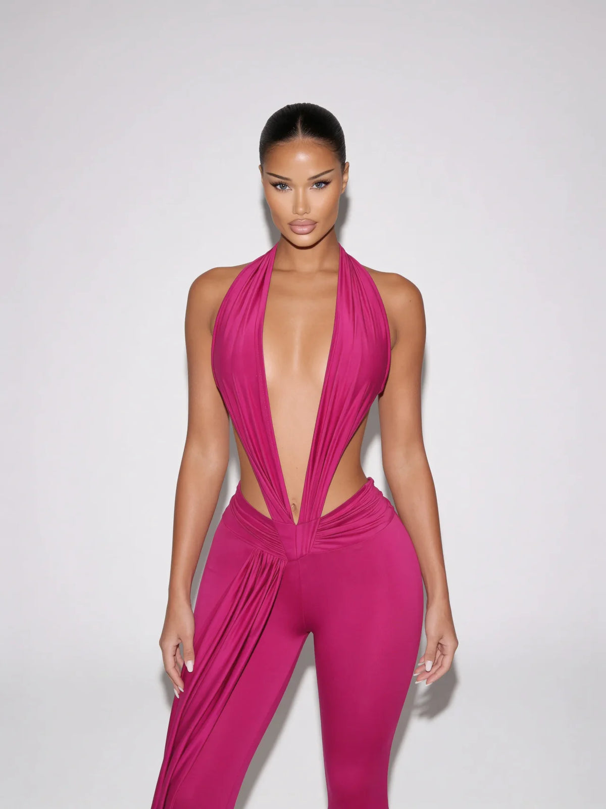 Samira fuchsia pink plunge halter jumpsuit with open sides and draped waist